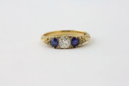 A DIAMOND AND SAPPHIRE RING, THE CENTRAL STONE FLANKED BY TWO OVAL SAPPHIRES, APPROX. .