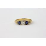 A DIAMOND AND SAPPHIRE RING, THE CENTRAL STONE FLANKED BY TWO OVAL SAPPHIRES, APPROX. .