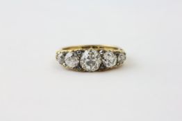 A FIVE STONE DIAMOND RING, THE CENTRAL OLD CUT DIAMOND APPROX.