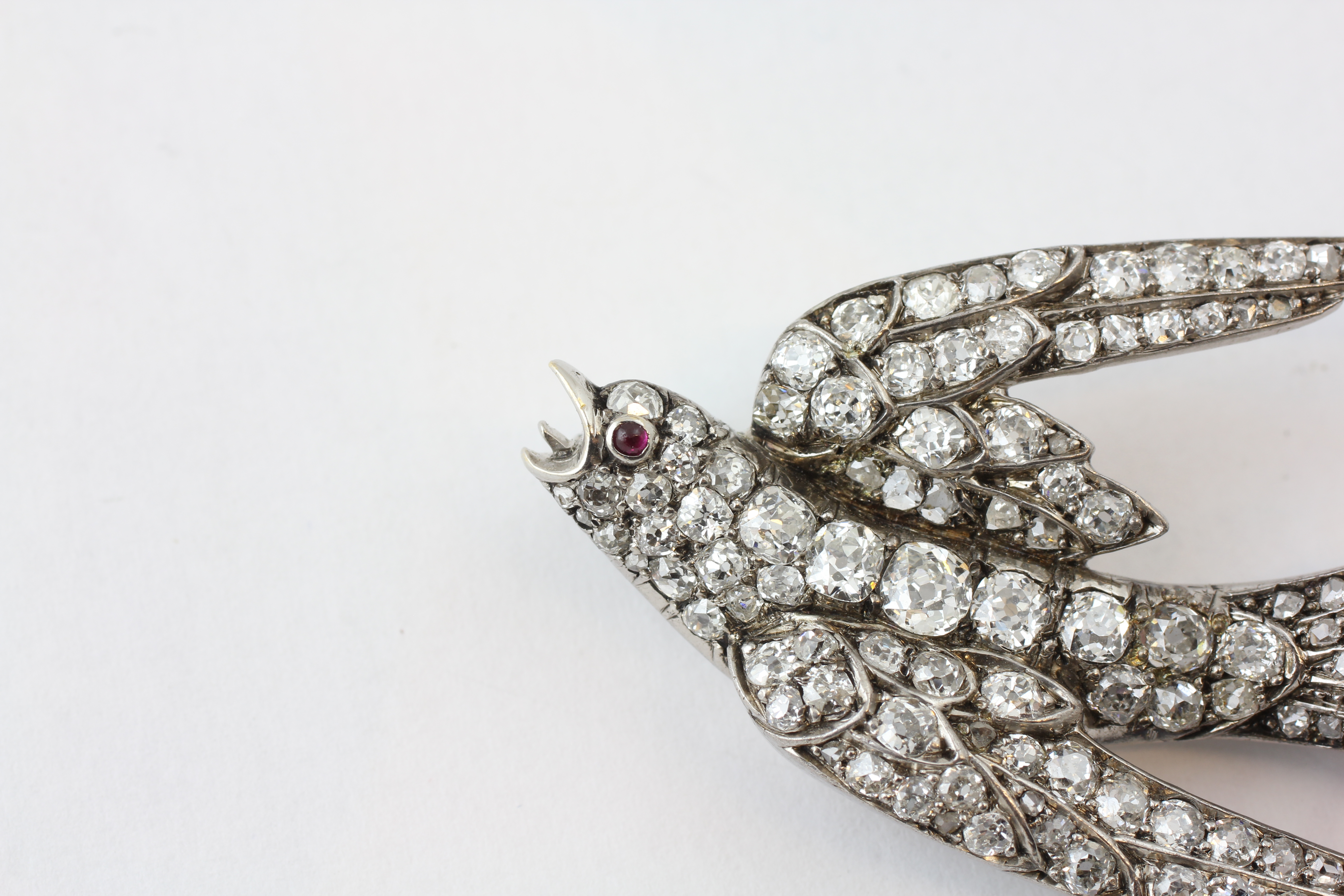 A DIAMOND SWALLOW BROOCH, THE EYE SET WITH A RUBY, LENGTH 58MM, THE LARGEST DIAMOND BEING 3MM, - Image 2 of 5