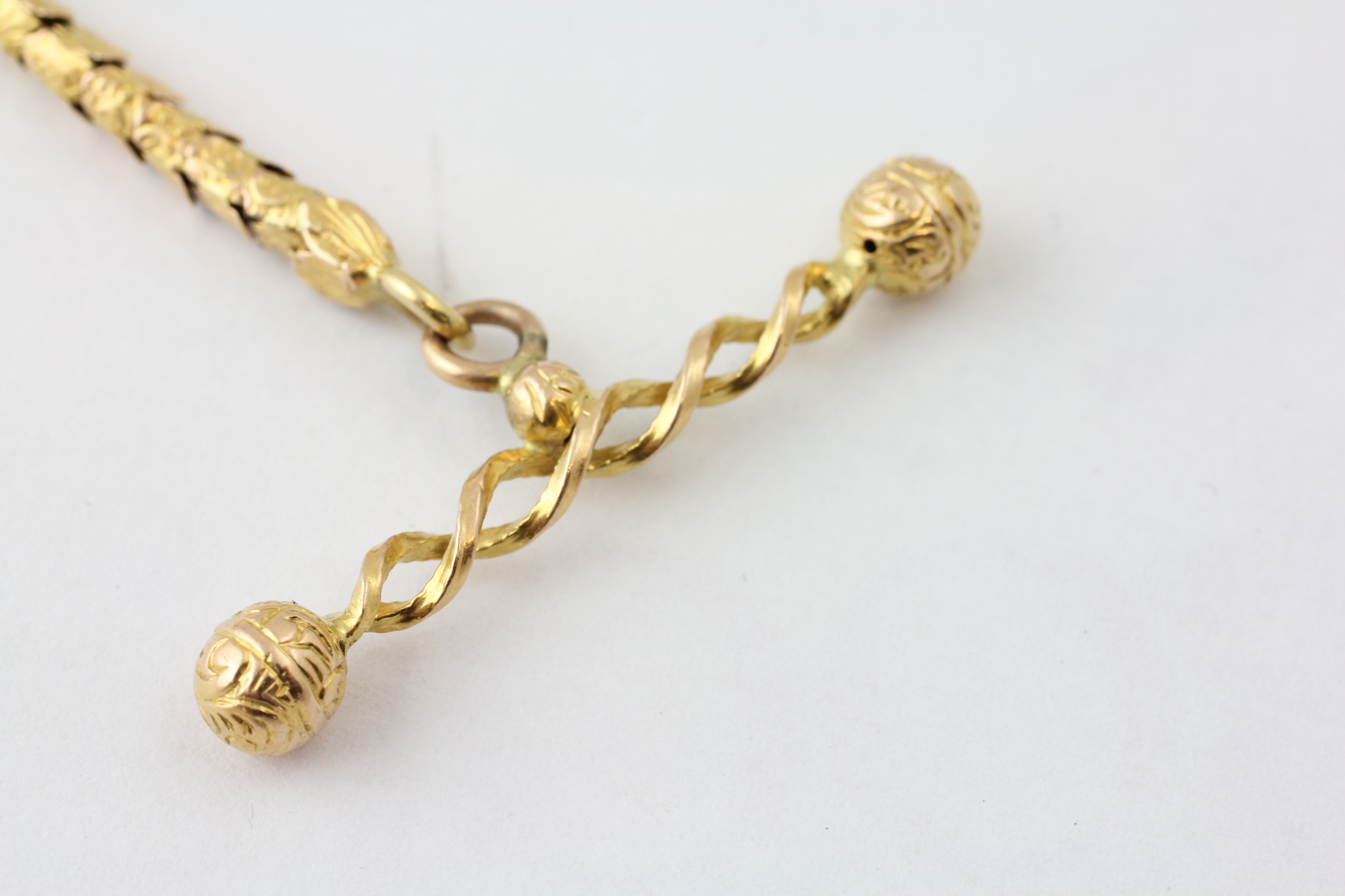 AN ARTICULATED WATCH CHAIN SET WITH RUBIES AND DIAMOND CHIPS, THE T BAR OF ROPE TWIST DESIGN, - Image 4 of 5