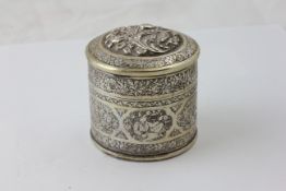 AN INDIAN SILVER CIRCULAR BOX AND COVER, DECORATED WITH SEATED FIGURES AND FLOWERS, DIAMETER 6.