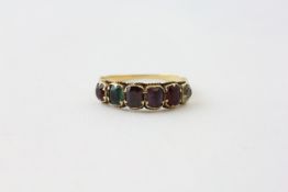 A RING SET WITH SIX DIFFERENT COLOURED STONES IN AN UNMARKED YELLOW METAL SETTING (DAMAGED AND