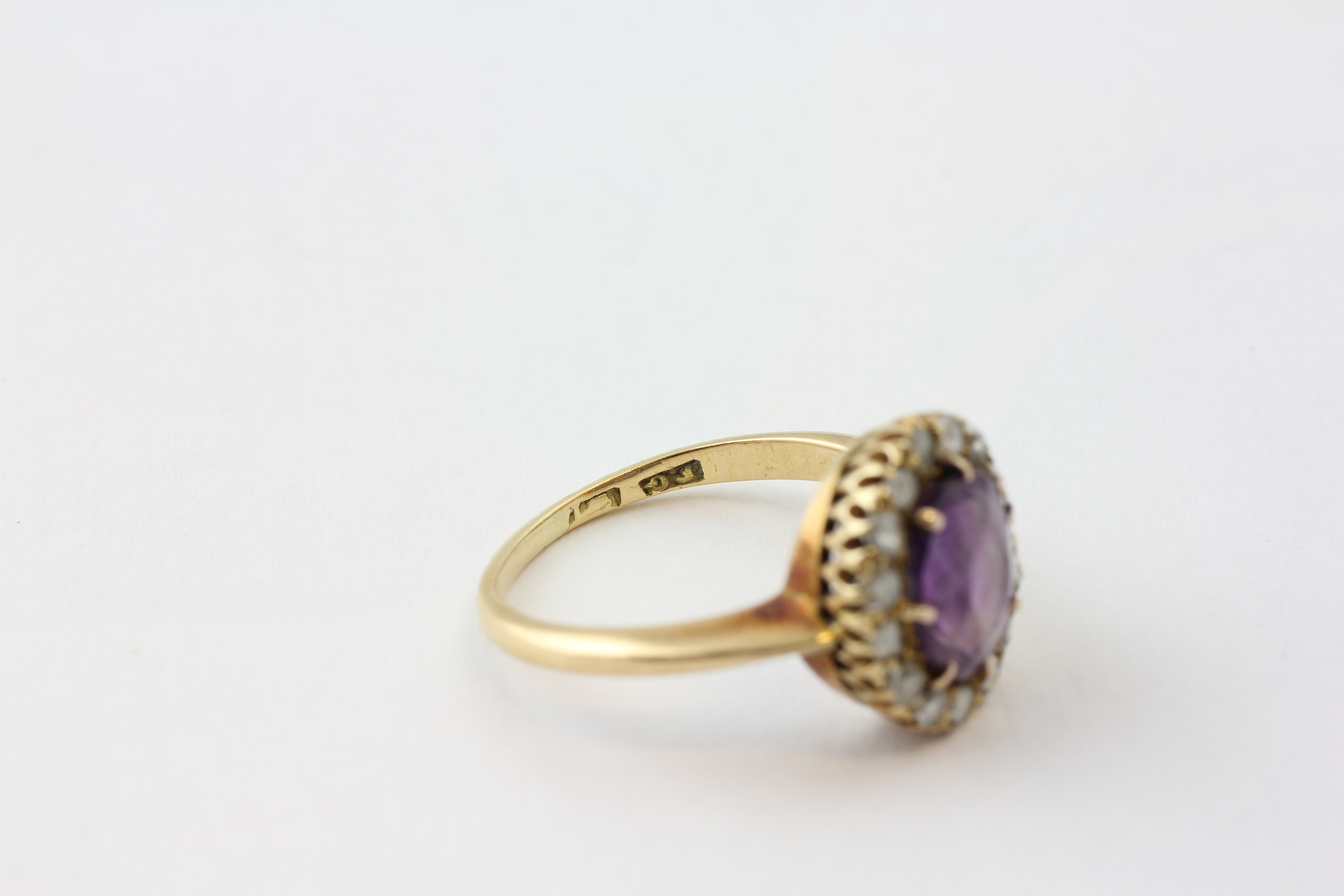 AN AMETHYST RING, THE OVAL STONE SURROUNDED BY FIFTEEN SMALL DIAMONDS SET IN YELLOW METAL, - Image 6 of 6