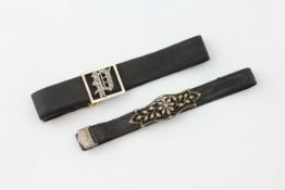 A 15CT AND DIAMOND MONOGRAM (P) BRACELET ON BLACK CLOTH STRAP ALONG WITH A WHITE METAL BRACELET ON