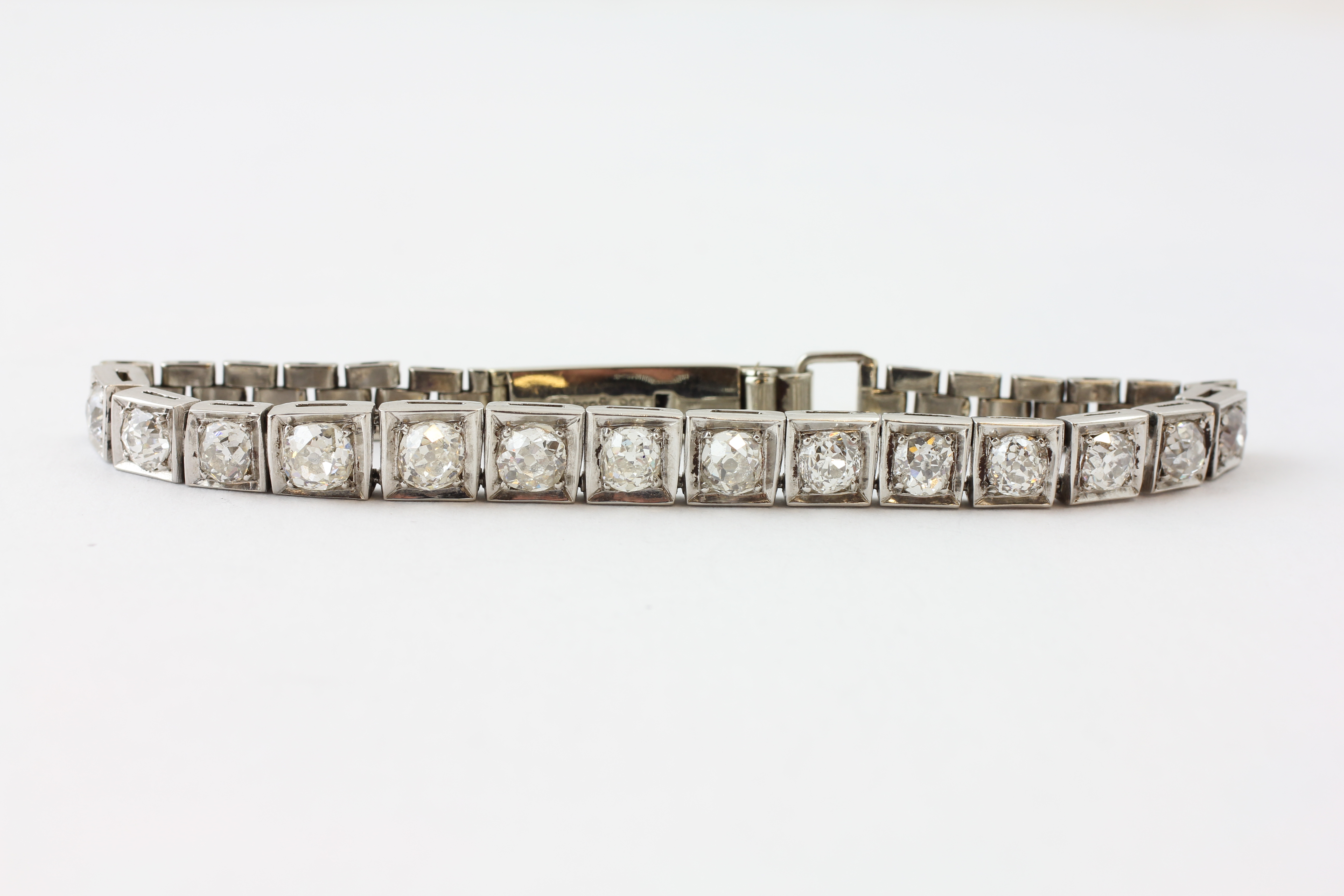 A FOURTEEN STONE DIAMOND BRACELET, THE OLD CUT STONES IN A 9CT WHITE GOLD SETTING,