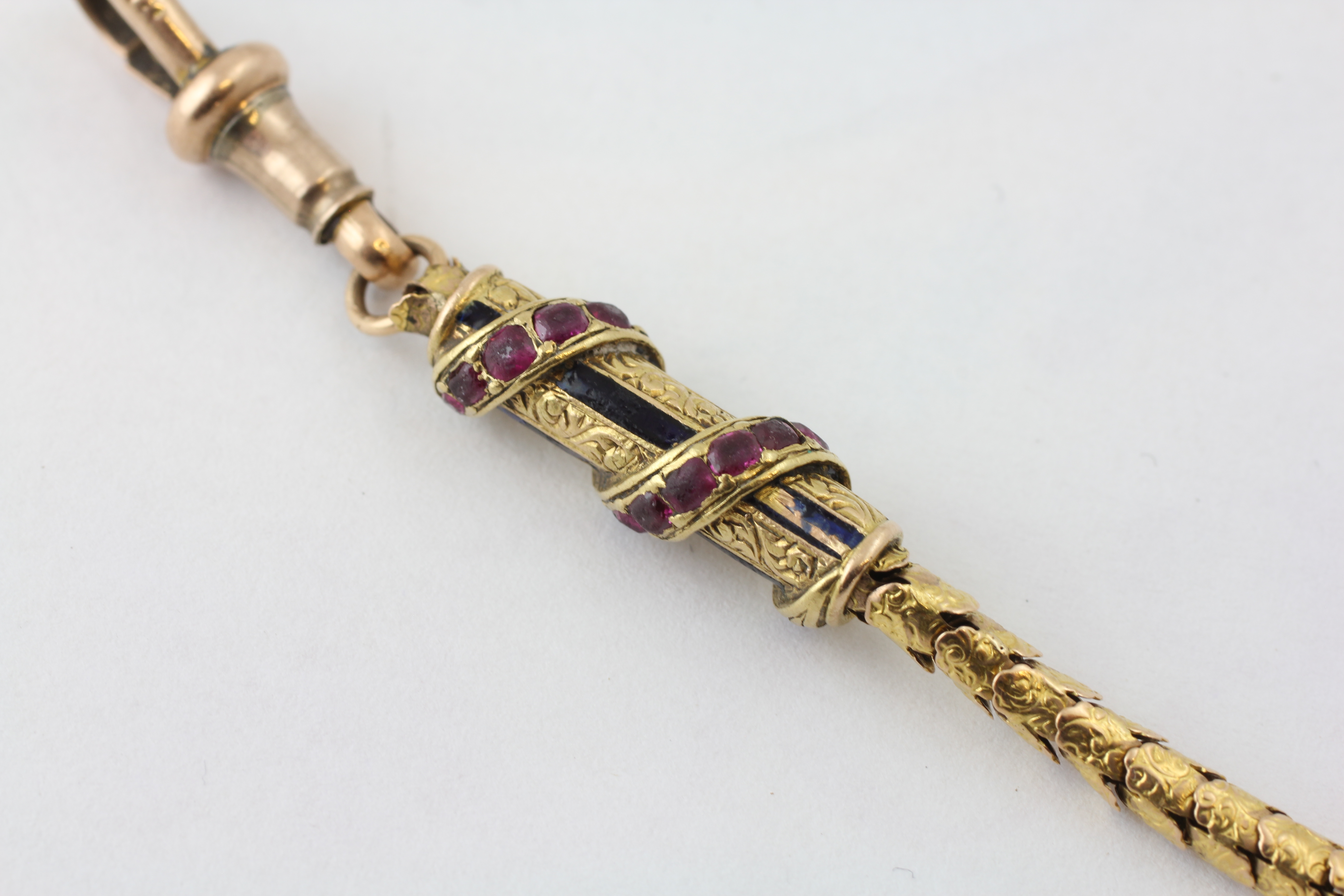 AN ARTICULATED WATCH CHAIN SET WITH RUBIES AND DIAMOND CHIPS, THE T BAR OF ROPE TWIST DESIGN, - Image 2 of 5