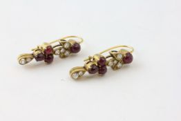 A PAIR OF DIAMOND AND RED CABOCHON EARRINGS SET IN UNMARKED YELLOW METAL,