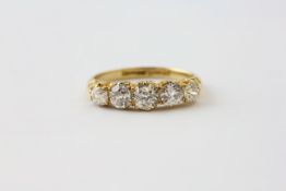 A FIVE STONE DIAMOND RING, THE BRILLIANT CUT STONES SET IN 18CT GOLD, THE LARGEST APPROX. .