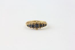 A SAPPHIRE RING, FIVE GRADUATED STONES, CLAW SET IN UNMARKED GOLD, THE LARGEST STONE APPROX.