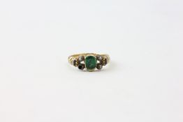 A RING SET WITH CENTRAL GREEN STONE,