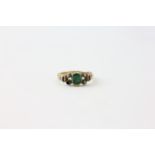 A RING SET WITH CENTRAL GREEN STONE,