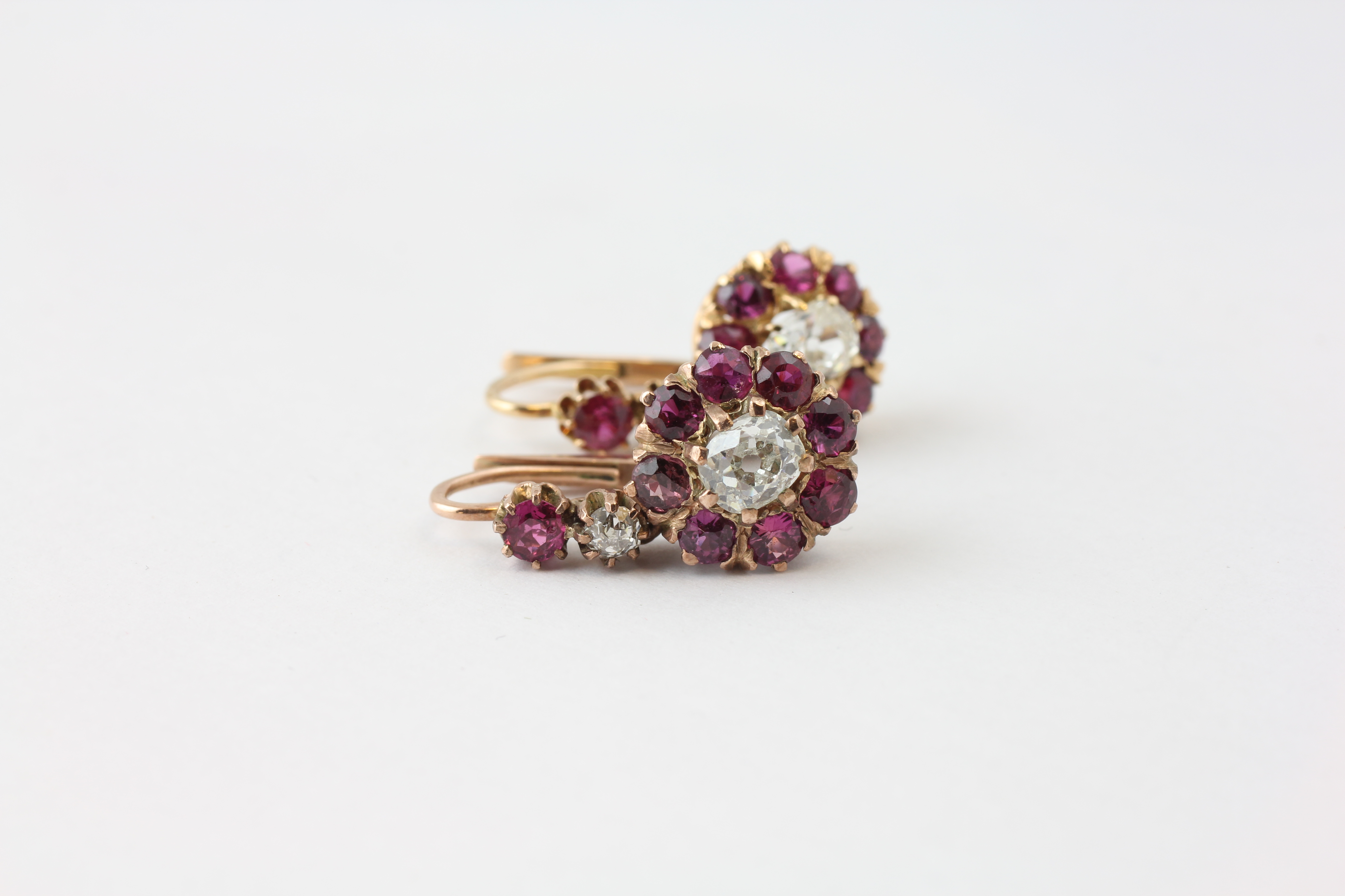 A PAIR OF DIAMOND EARRINGS, THE CENTRAL OLD CUT STONE SURROUNDED BY SMALL MAUVE STONES, - Image 2 of 6