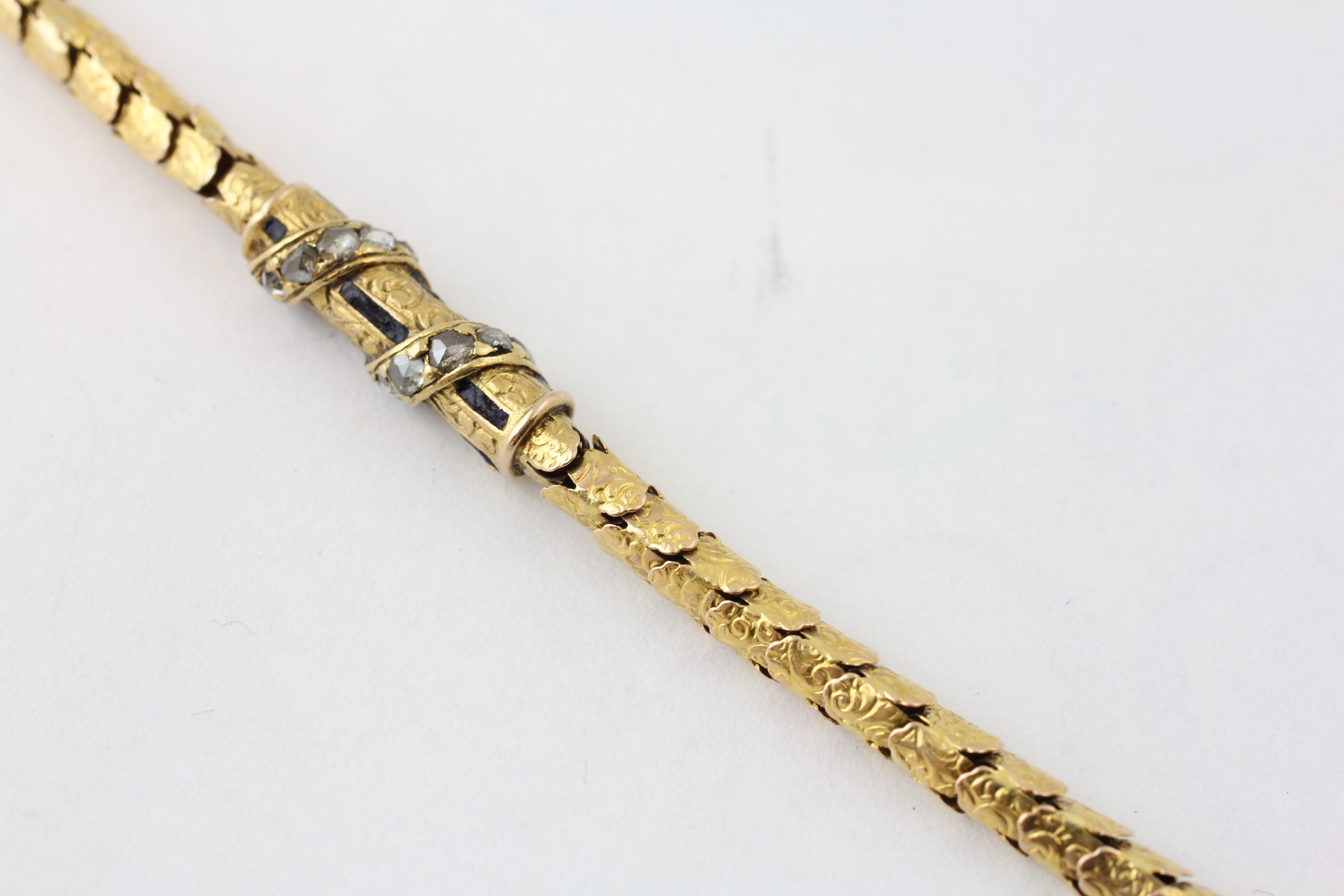 AN ARTICULATED WATCH CHAIN SET WITH RUBIES AND DIAMOND CHIPS, THE T BAR OF ROPE TWIST DESIGN, - Image 5 of 5