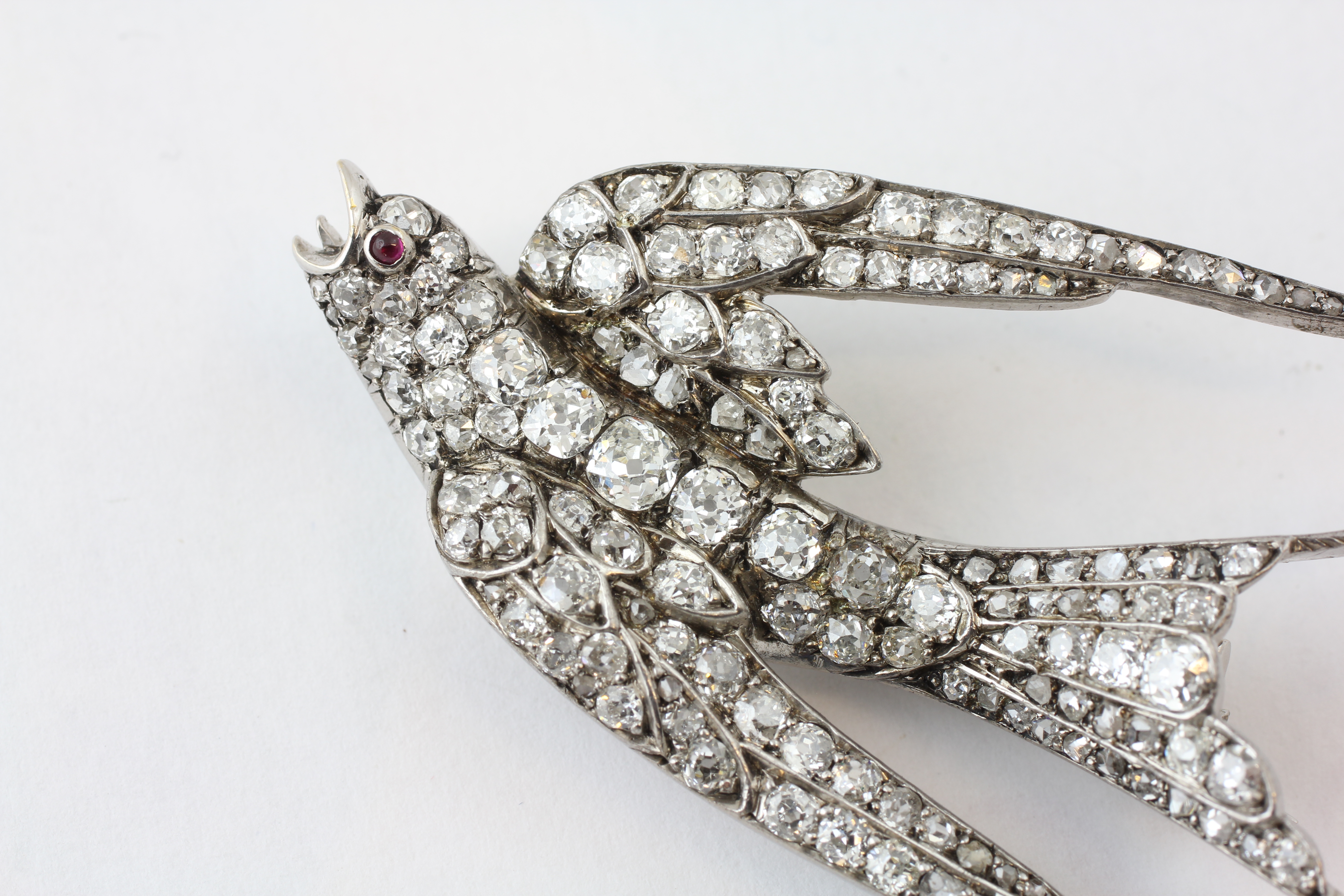 A DIAMOND SWALLOW BROOCH, THE EYE SET WITH A RUBY, LENGTH 58MM, THE LARGEST DIAMOND BEING 3MM, - Image 3 of 5