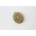 AN UNMARKED YELLOW METAL LOCKET OF FILIGREE DESIGN, ASSUMED 9CT., HEIGHT 38MM.