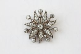 A DIAMOND BROOCH OF FLOWERHEAD AND LEAF DESIGN, SET WITH 43 OLD CUT DIAMONDS,