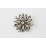 A DIAMOND BROOCH OF FLOWERHEAD AND LEAF DESIGN, SET WITH 43 OLD CUT DIAMONDS,