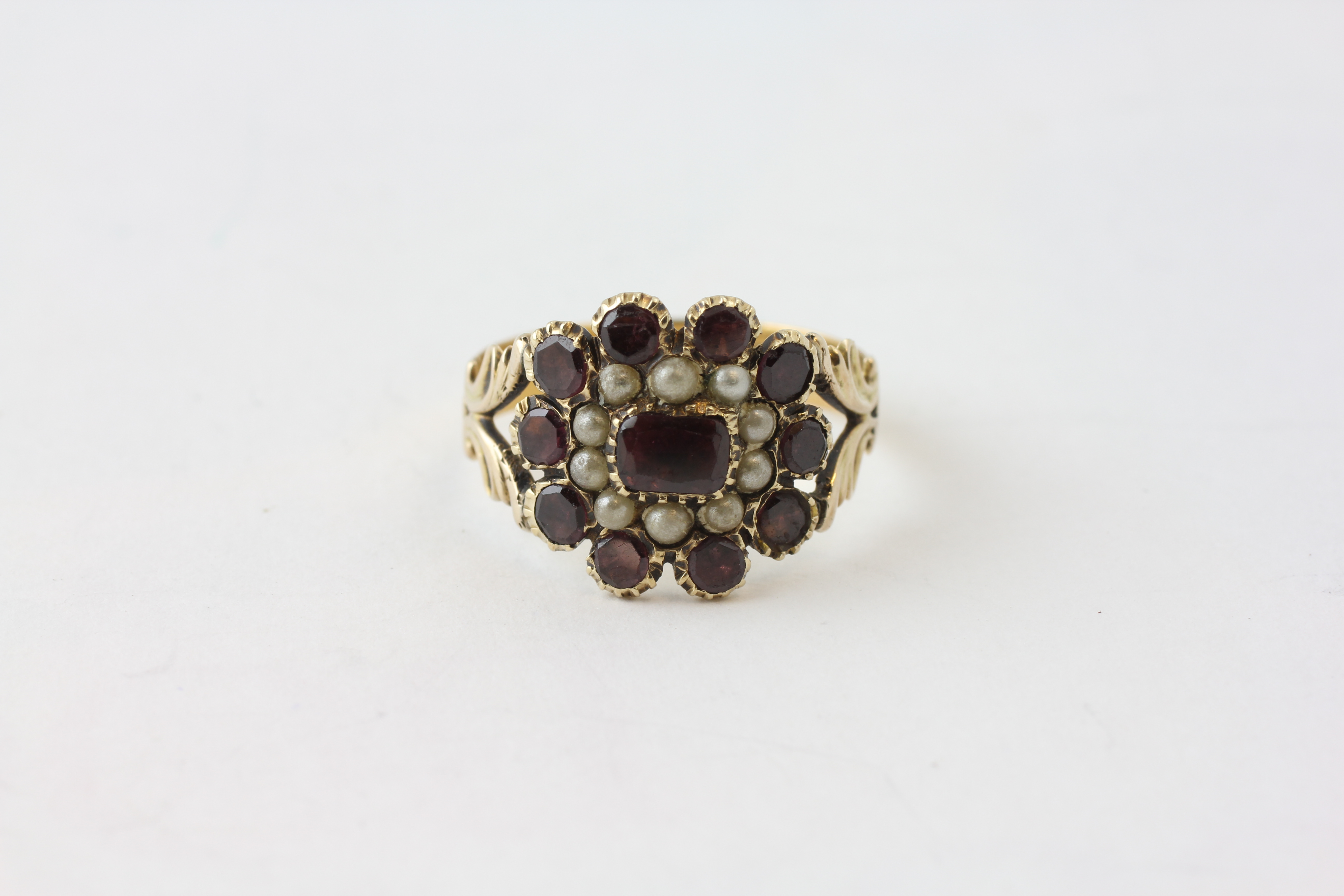 A VICTORIAN PEARL AND AMETHYST SET RING WITH PIERCED SHOULDERS, SET IN 22CT GOLD,