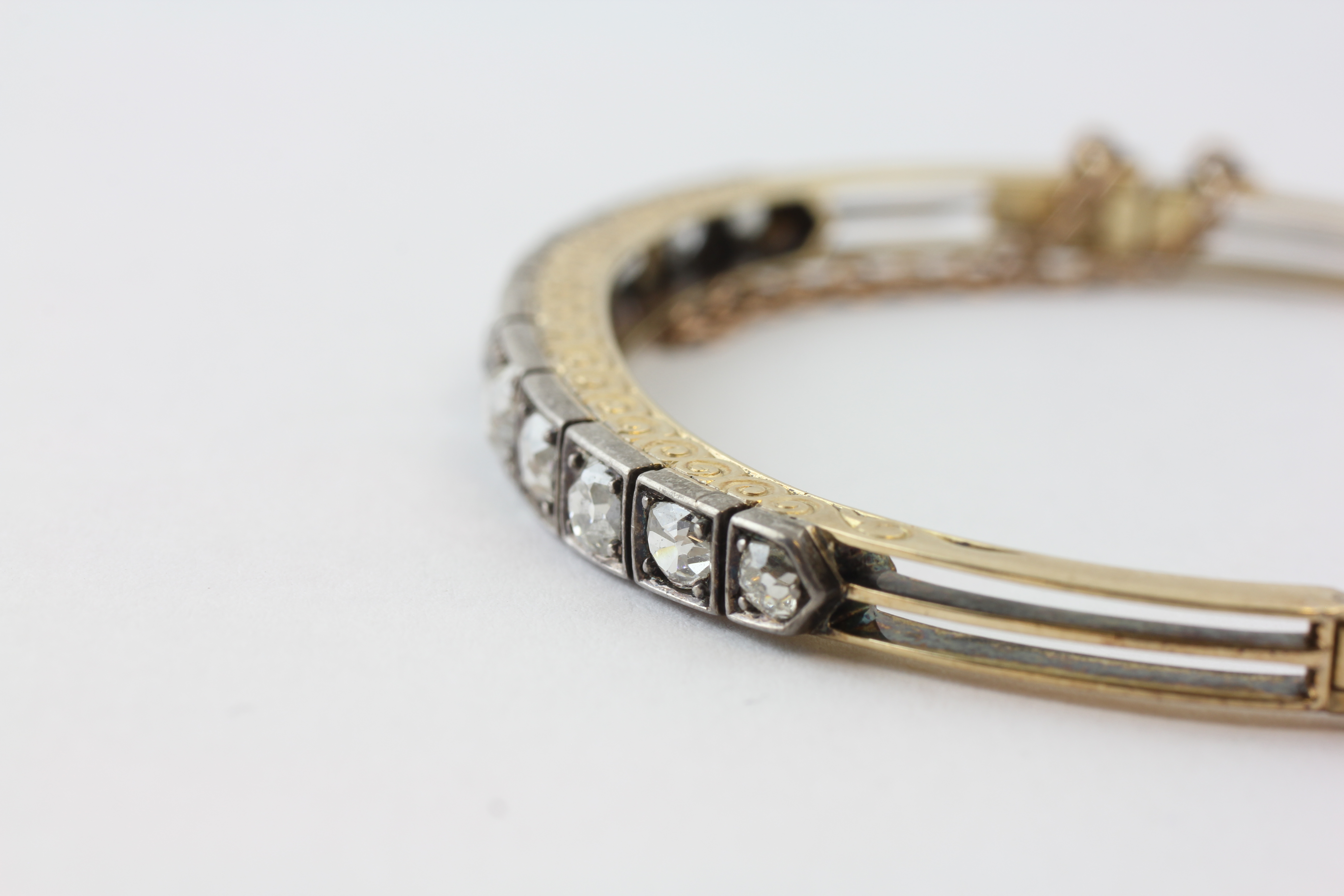 AN ELEVEN STONE DIAMOND HINGED BANGLE WITH SAFETY CHAIN, - Image 6 of 7