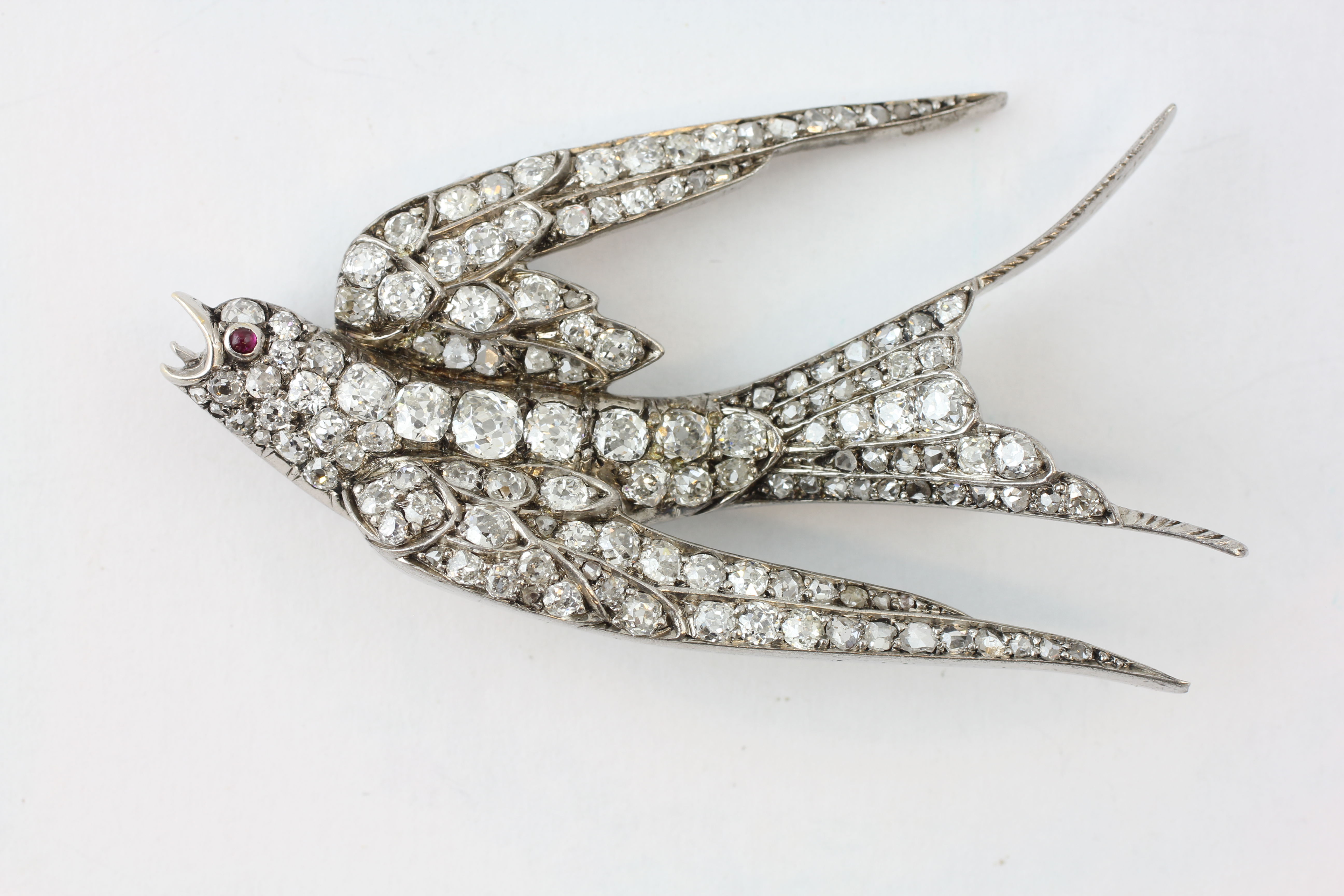 A DIAMOND SWALLOW BROOCH, THE EYE SET WITH A RUBY, LENGTH 58MM, THE LARGEST DIAMOND BEING 3MM, - Image 5 of 5