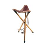 WESTLEY RICHARDS & CO. A FINE AND UNUSED LIGHTWEIGHT WOOD AND LEATHER TRIPOD SEAT, with leather