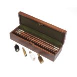 A NEW AND UNUSED CASED 12-BORE GUN-CLEANING KIT, consisting of an oak and brass cleaning rod, brush,
