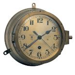 AN EIGHT-DAY BRASS GERMAN WORLD WAR TWO KRIEGSMARINE BULKHEAD CLOCK, serial no. 9937N (6476), of the