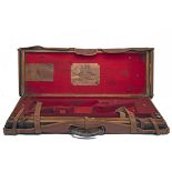 JAMES WOODWARD & SONS A BRASS-CORNERED OAK AND LEATHER DOUBLE GUNCASE, fitted for 29in. barrels, the