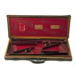 JAMES PURDEY & SONS A BRASS-CORNERED OAK AND LEATHER DOUBLE GUNCASE, fitted for 29in. barrels (could