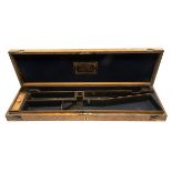 A VINTAGE BRASS-CORNERED OAK SINGLE GUNCASE, fitted for 30in. barrels, the interior lined with