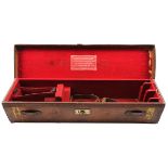 A LEATHER DOUBLE GUNCASE, fitted for 28in. barrels, the interior lined with red baize, a red leather
