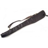 A LEATHER FLEECE-LINED SINGLE GUNSLIP, measuring approx. 50in., with leather shoulder strap and