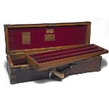 JAMES PURDEY & SONS A BRASS-MOUNTED TWO-TIER OAK AND LEATHER TRIPLE GUNCASE, fitted for 30in.