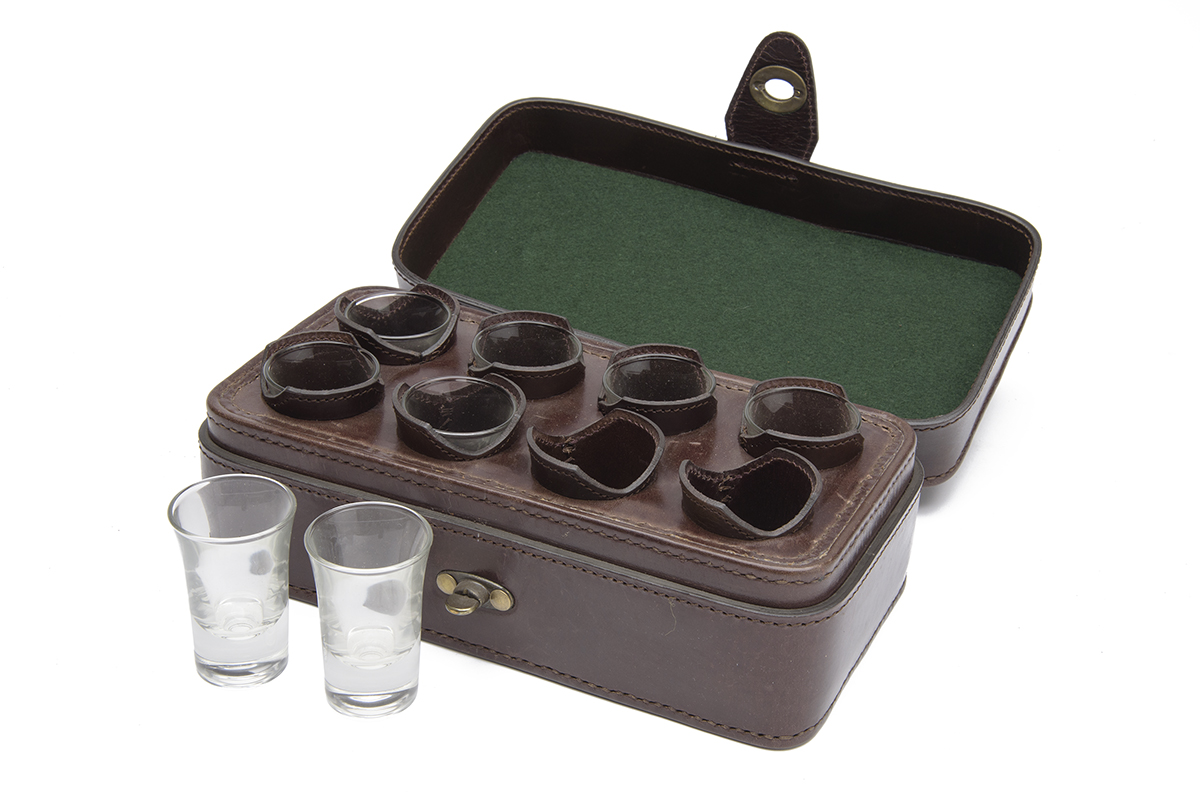 REY PAVON A LEATHER CASED EIGHT SHOT GLASS SET, dark leather case with leather interior. † Please