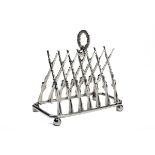 A TOAST RACK IN THE FORM OF CROSSED GUNS, the rack formed with triangulated percussion guns