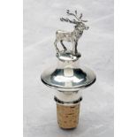 A STERLING SILVER STAG TOPPED CORK BOTTLE STOPPER, with 925 silver hallmarks, measuring approx.