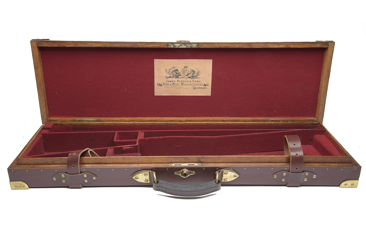 A BRASS-CORNERED OAK AND LEATHER SMALL-BORE SINGLE GUNCASE, fitted for 28in. barrels, the interior