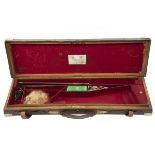 JAMES PURDEY & SONS A BRASS-CORNERED OAK AND LEATHER SINGLE GUNCASE, fitted for 29in. barrels, the