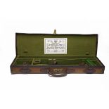 A BRASS-CORNERED CANVAS AND LEATHER SINGLE HAMMERGUN CASE, fitted for 28in. side by side barrels,