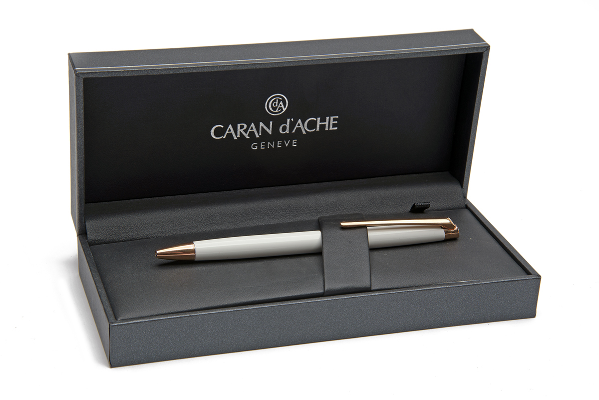 CARAN D'ACHE, SWITZERLAND A BOXED 'WHITE & ROSE-GOLD' FINISHED SLIMLINE BALLPOINT PEN, MODEL '