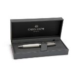 CARAN D'ACHE, SWITZERLAND A BOXED 'WHITE & RHODIUM' FINISHED BALLPOINT PEN, MODEL 'LEMAN', ref