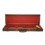 A BRASS-CORNERED OAK AND LEATHER SINGLE GUNCASE, fitted for 30in. barrels, the interior lined with