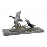 A BRONZE SCULPTURE OF TWO MALLARD DUCKS TAKING FLIGHT, unsigned, mounted on a marble plinth,