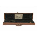 A LEATHER LIGHTWEIGHT SINGLE GUNCASE, fitted for 29in. barrels, the interior lined with green