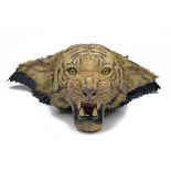 A VINTAGE HEAD MOUNT OF A TIGER, circa 1930's, beige and canvas lined mounted on a wooden plaque.