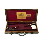 BOSS & CO. A BRASS-CORNERED OAK AND LEATHER DOUBLE GUNCASE, fitted for 29in. barrels, the interior