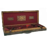 THOMAS BLAND & SONS A BRASS-CORNERED OAK AND LEATHER DOUBLE GUNCASE, fitted for 30in. barrels, red