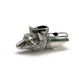 A SILVER FOX WHISTLE, in the form of a fox head, the nose with lanyard ring, measuring approx. I 5/