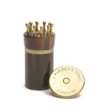 JAMES PURDEY & SONS A BRASS AND HORN 10-PEG PLACEFINDER IN THE FORM OF A 4-BORE CARTRIDGE, brass